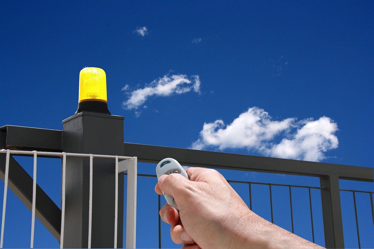 hand with remote control, automatic gate, gate opening, industry gate, flashing yellow, automatic gate, automatic gate, automatic gate, automatic gate, automatic gate